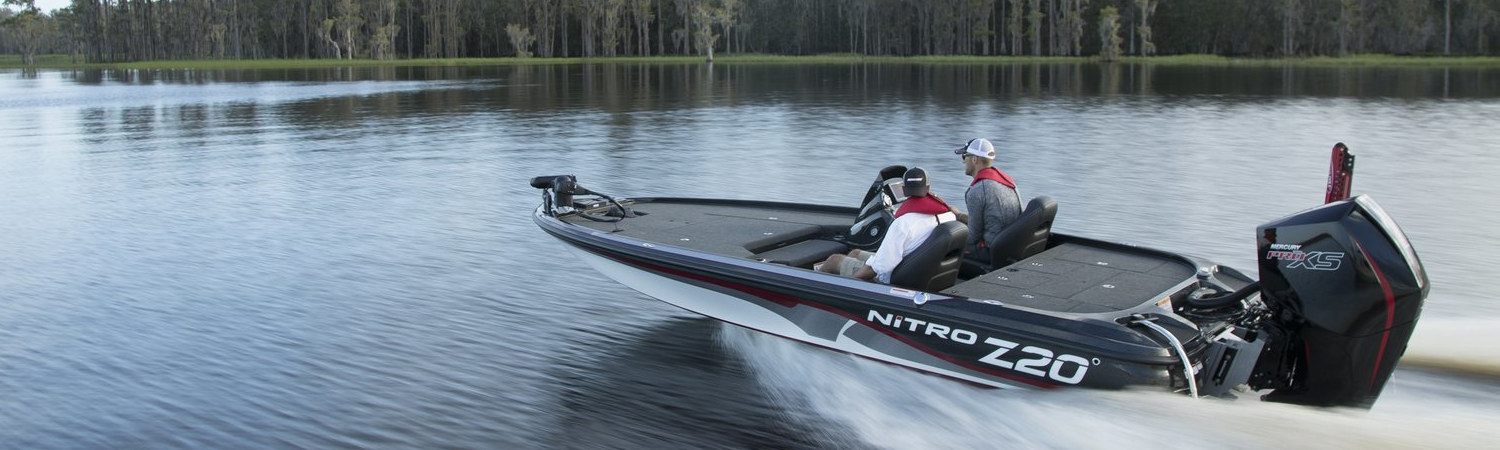 Two people on a 2020 Mercury 115 boat dashing through a lake.