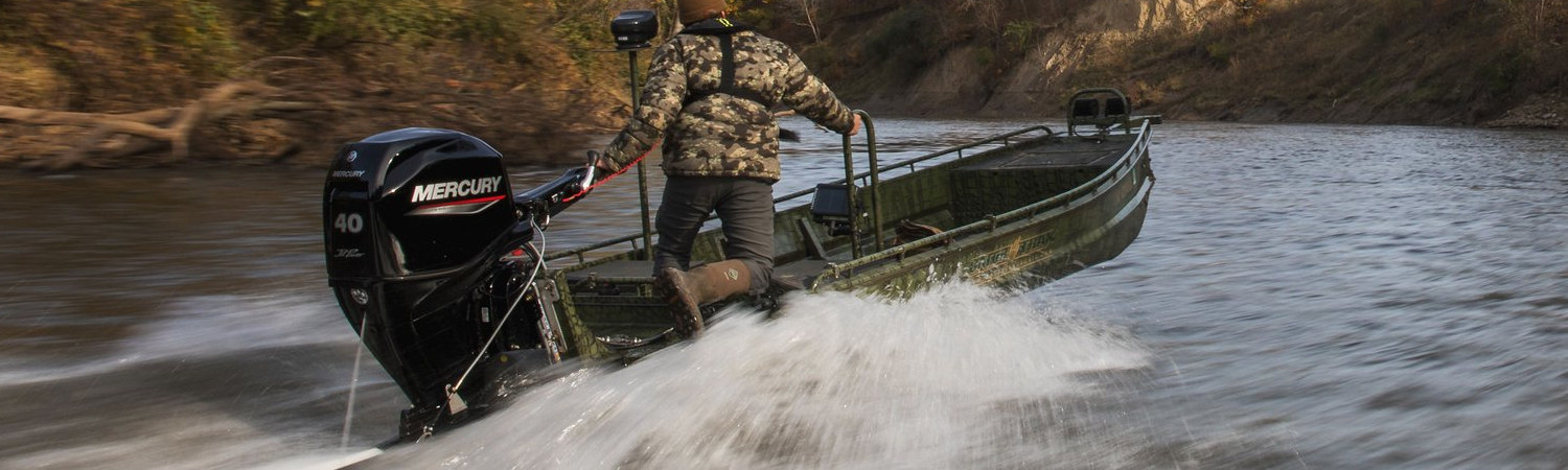 A man jetting through river waters in a canyon and spraying waters behind him.